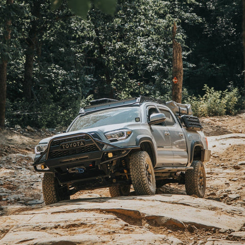 Baby blue four-door Tacoma fully outfitted for overlanding and with a C4 Hybrid front winch bumper.