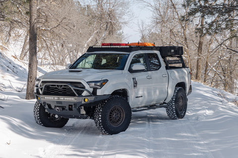 Toyota Tacoma on a snowy road with C4 fabrication off road bumper.