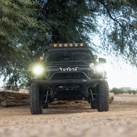 Toyota Tacoma with 4th gen 2024+ Tacoma Rock Runner Front Bumper installed, and headlights on