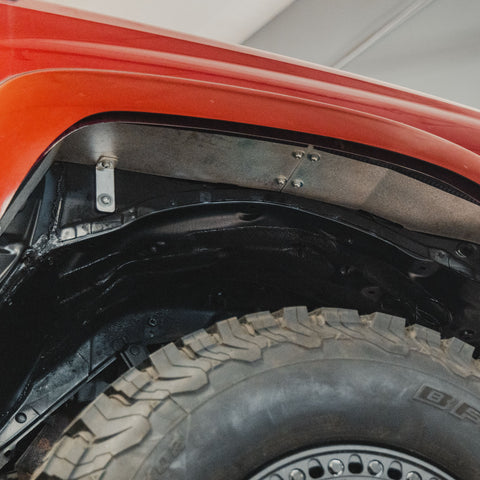 Low-angle view looking forward to the seam of the C4 high clearance fender liner kit.
