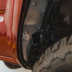 View of the bottom rear portion of the C4 High Clearance Fender Liner kit with the C4 logo. 
