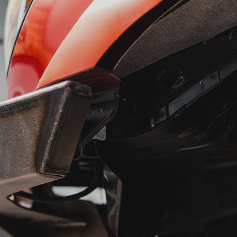 View of a trimmed and capped C4 Overland bumper after it has been modified to match the new larger wheel well opening after installation of the C4 High Clearance Fender Liner kit.