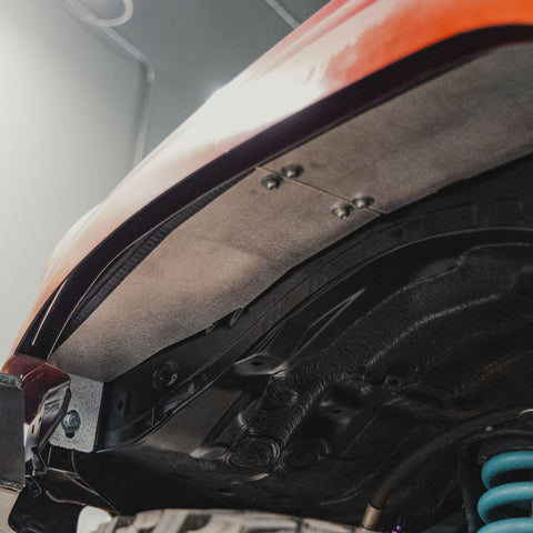 View from a low angle looking forward at the front portion of the High Clearance Fender Liner Kit from C4 Fabrication.