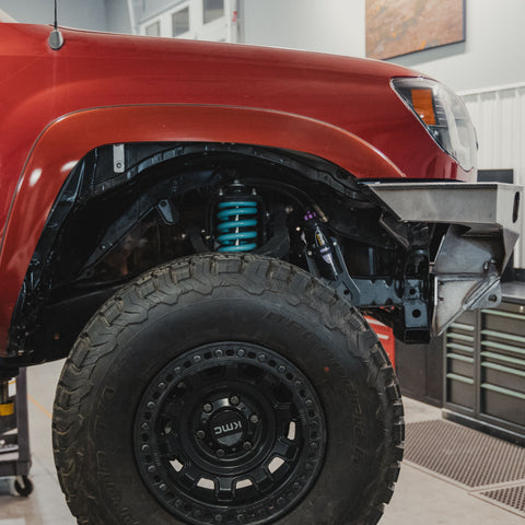 View of the passenger side of a Tacoma after it's been trimmed for the install of the C4 High Clearance Fender Liner kit.