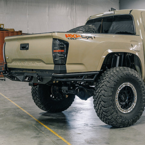 C4 Rock Runner High Clearance Rear Bumper with double tube sides installed on a tan Tacoma.