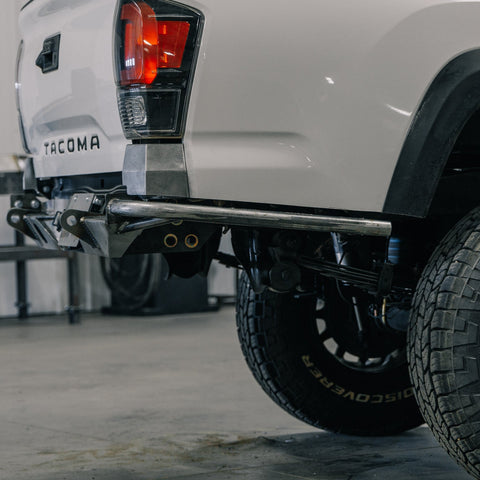 Close-up side view of the C4 Rock Runner High Clearance rear bumper with the single slant tube side wing.