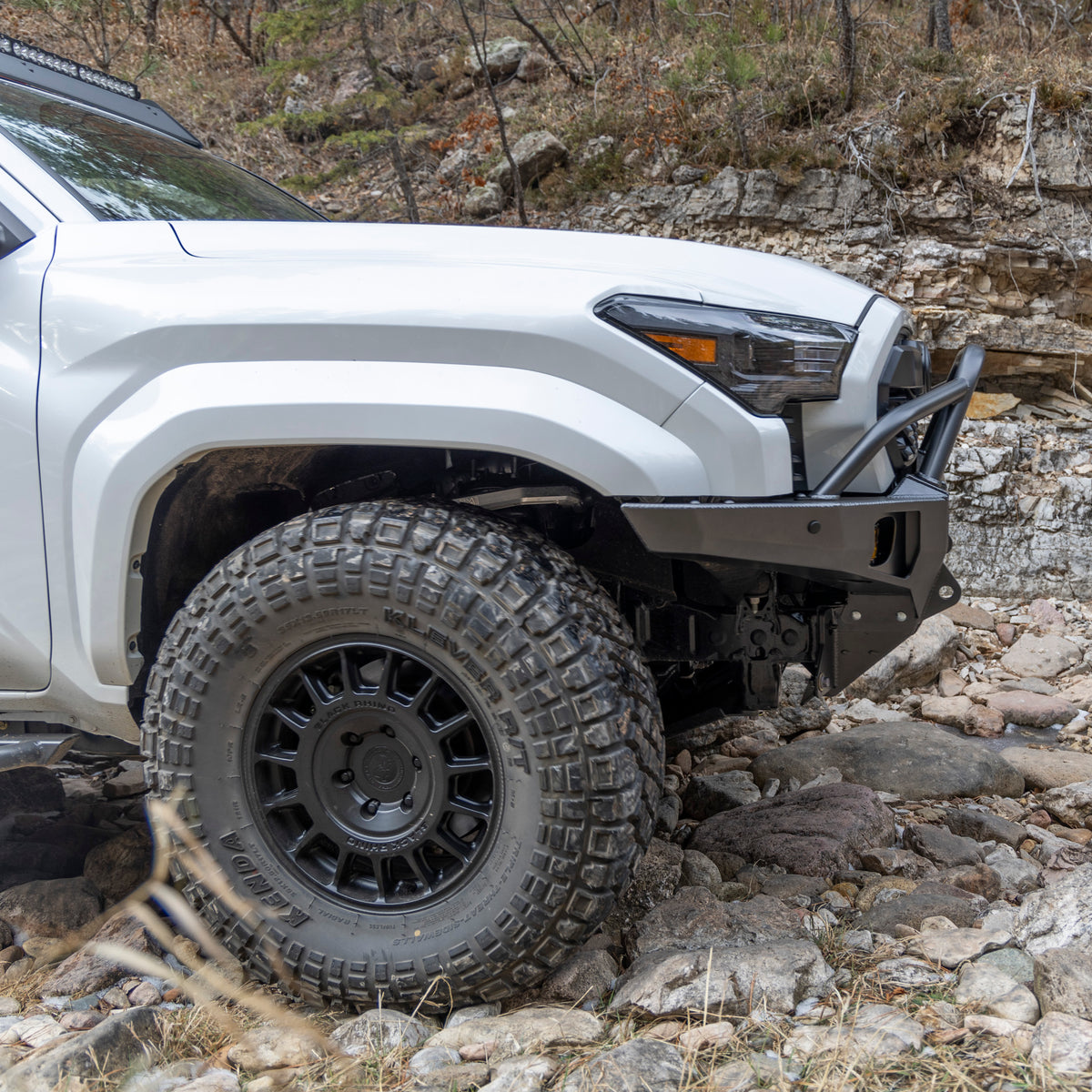 Side view of the C4 Overland winch bumper with mid-height bull bar and tube gussets illustrating the tight fitment of the bumper to the factory bodywork and grille.