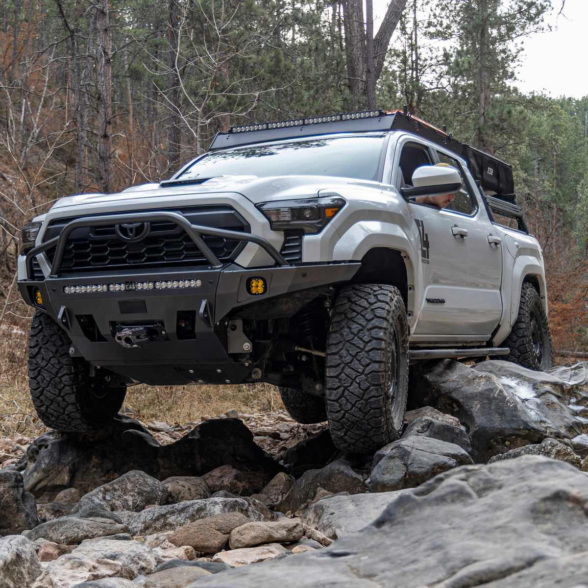 2024 Tacoma navigating a rock garden and equipped with a C4 Fabrication Overland winch bumper.