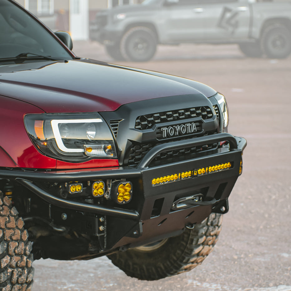 Cover photo for the C4 Hybrid front winch bumper for the 2005 Toyota Tacoma with emphasis on the truck and bumper and the background faded out.