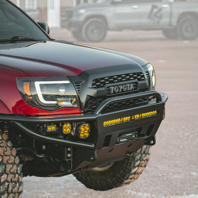 Cover photo for the C4 Hybrid front winch bumper for the 2005 Toyota Tacoma with emphasis on the truck and bumper and the background faded out.