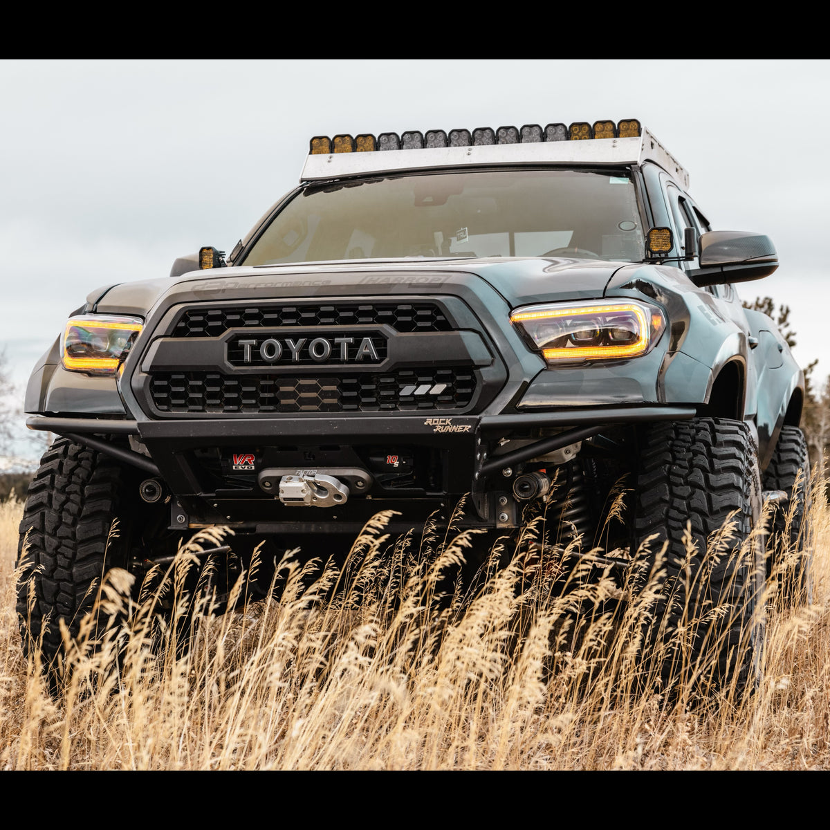 Wide body 3rd Gen Tacoma with the C4 Rock Runner front bumper with wide tube wings.