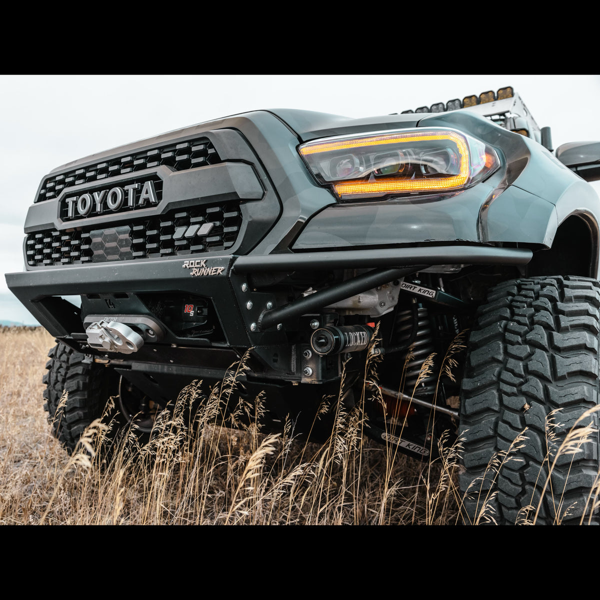 Low angle quartering front view of the C4 Rock Runner front bumper for wide-body Tacomas.