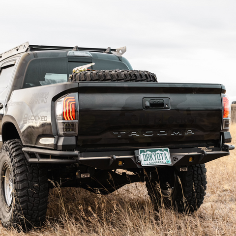 Black Tacoma with double tube side variant of the C4 Rock Runner bumper.