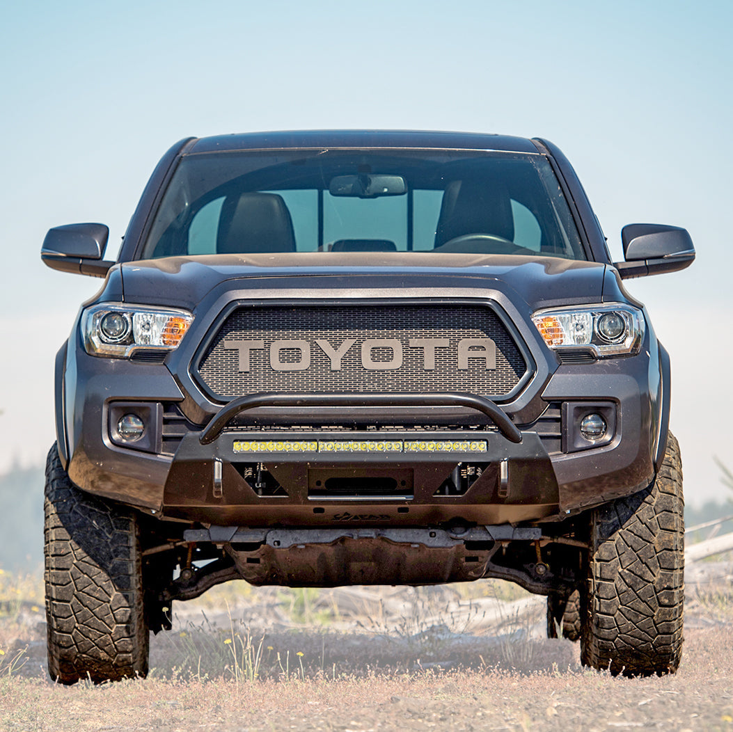 Cover photo for the C4 Lo-Pro front winch bumper for the 3rd Generation Toyota Tacoma with the background faded out and emphasis on the truck and its bumper.