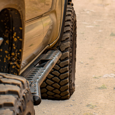 Cover photo for the C4 Fabrication rock sliders built for the 3rd Generation Tacoma with emphasis on the truck and sliders and the background faded away.