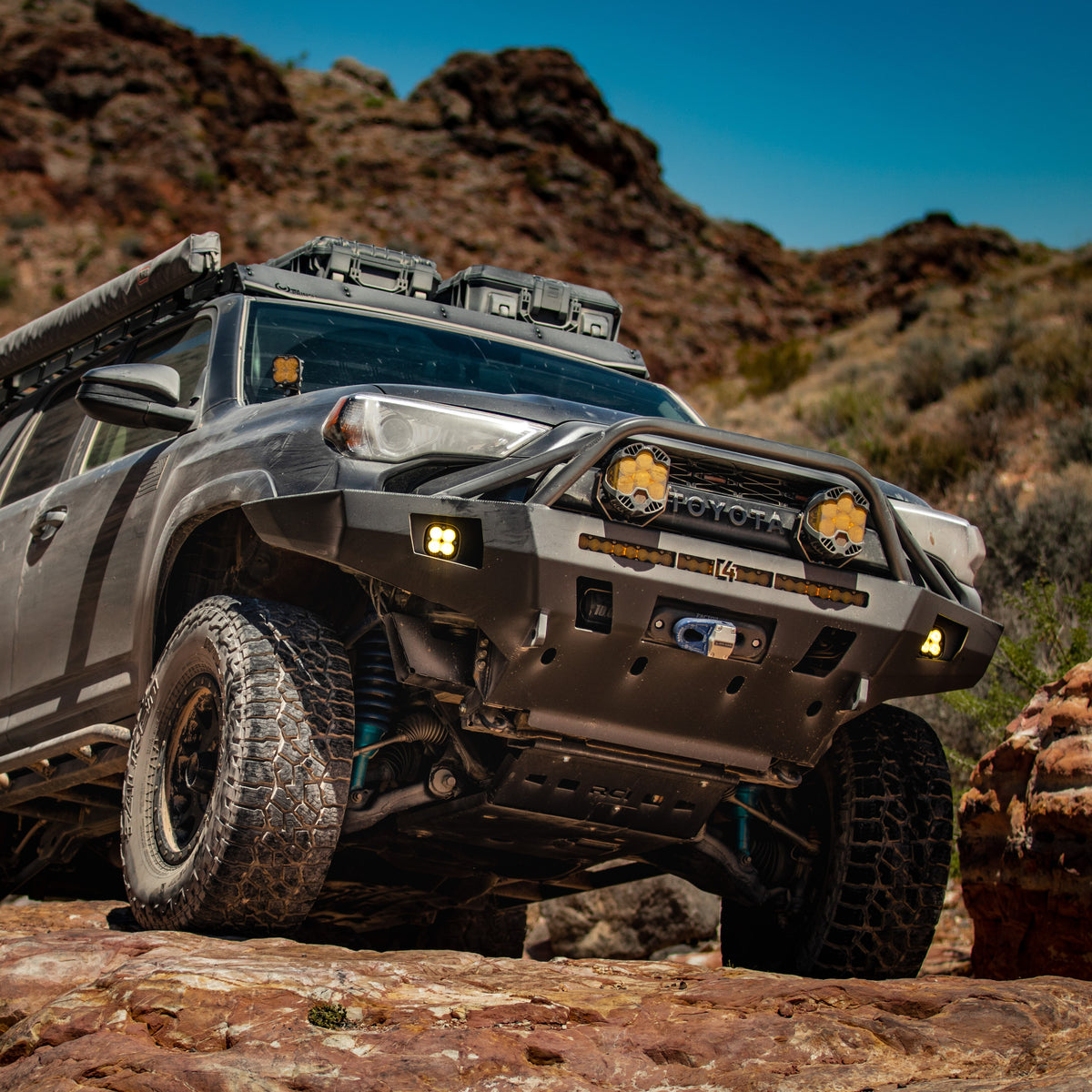 Low angle photo showing the C4 Overland bumper installed on a 5th Gen 4Runner on a heavily-modified grey 4Runner.