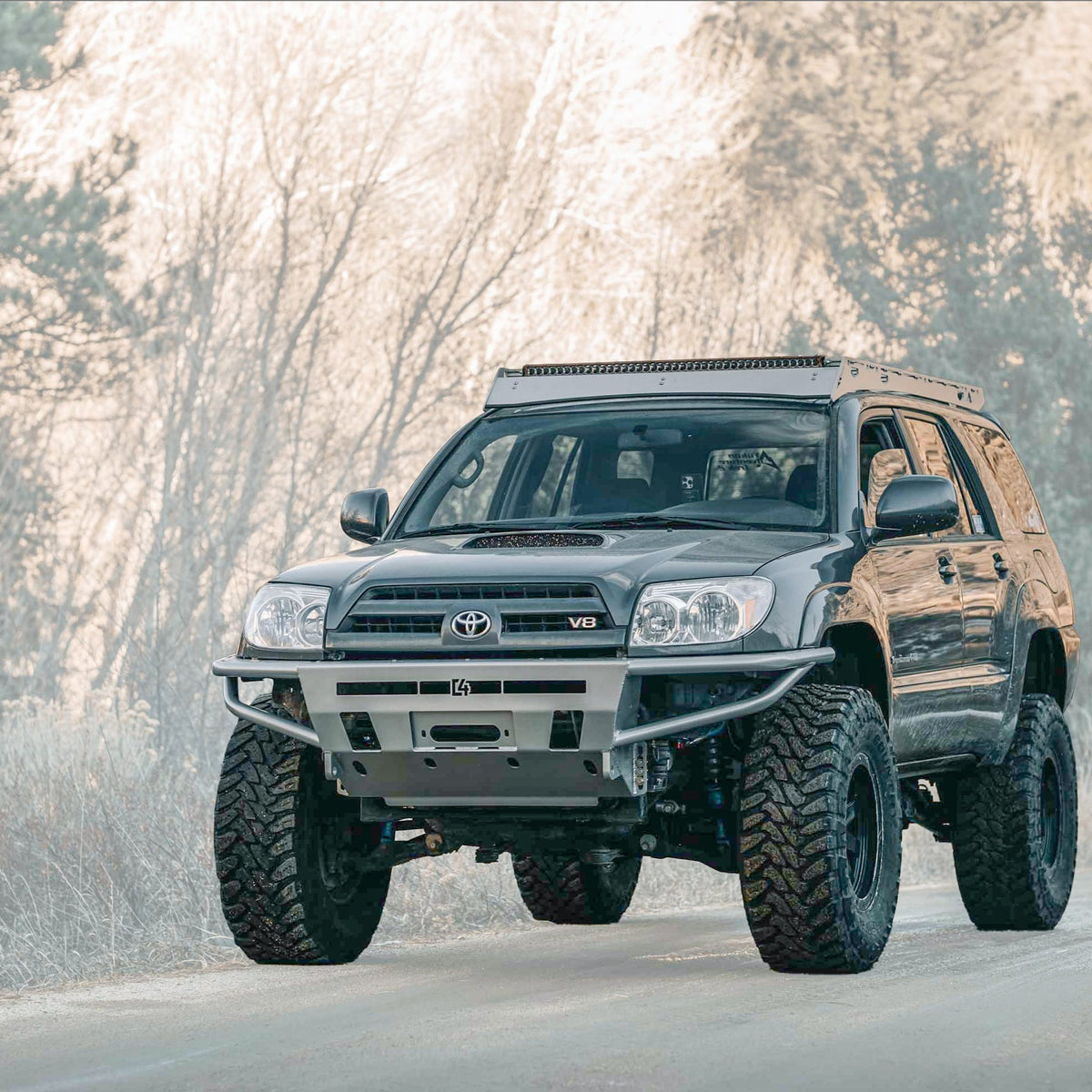 Cover photo for the 4th Gen Toyota 4Runner Hybrid winch bumper from C4 Fabrication with emphasis on the 4Runner and its bumper and the background faded out.