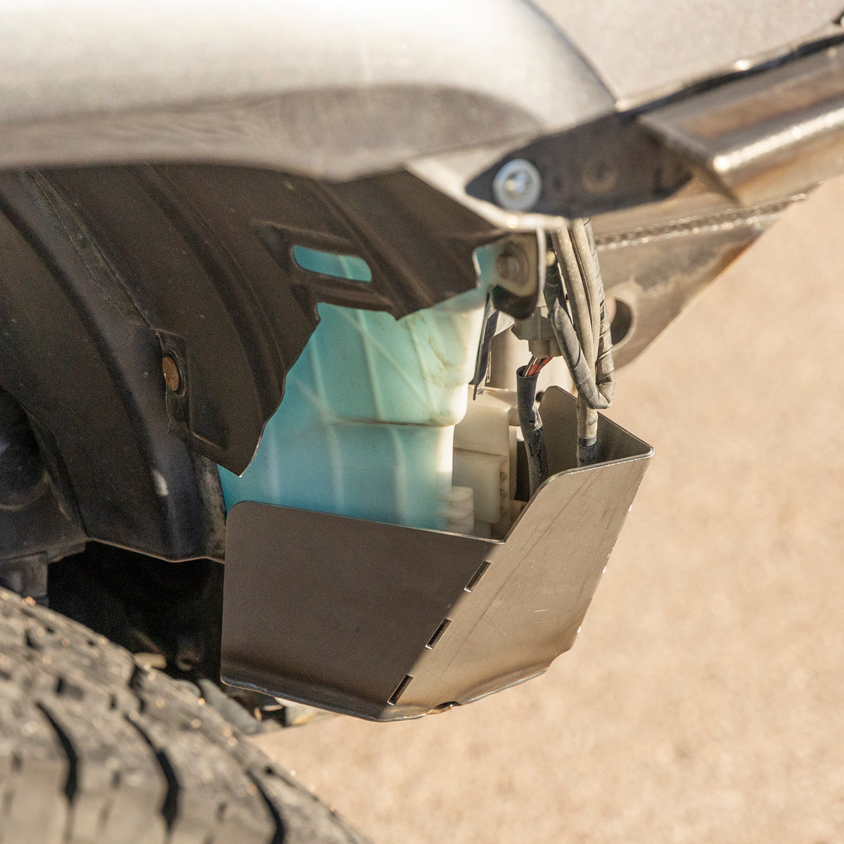 View of the C4 Washer Tank Skid from the rear, showing how it protects the plastic washer tank bottle on 4Runners from damage due to rock strikes.