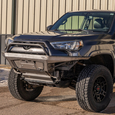 Driver's side angle view of a grey Toyota 4Runner with a C4 Rock Runner bumper with bull bar and plate sides.