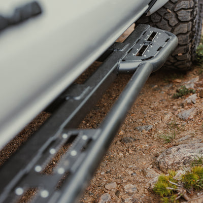 Close-up view of the C4 slider for the 4th Generation Tacoma showing the rear kick-out that protects the cab corner and bed from rocks as well as the serrated step inserts that provide grip for people using it as a step.