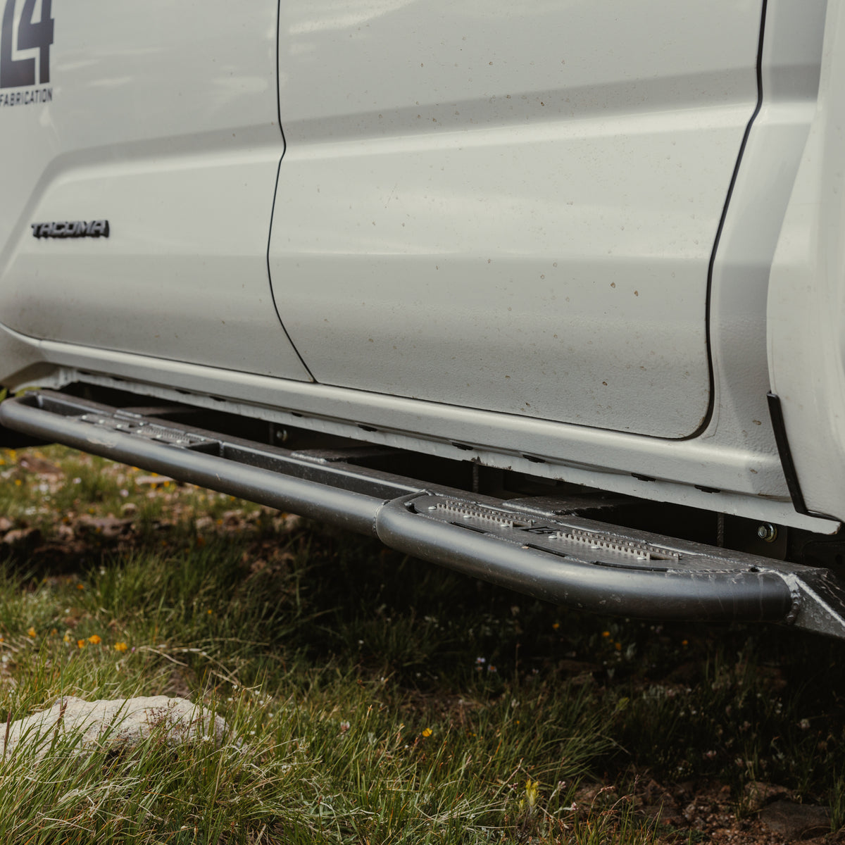 Lower angle view of the C4 Sliders for the 2024 Tacoma showing how much clearance the slider has from the bottom of the cab.