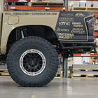Low-angle side view showing the extreme departure angle provided by the C4 Rock Runner rear bumper for the 3rd Gen Tacoma.