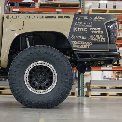 Low-angle side view showing the extreme departure angle provided by the C4 Rock Runner rear bumper for the 3rd Gen Tacoma.