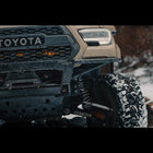 Close-up view of the Rock Runner bumper with the RCLT HD long travel rock crawling long travel system on a tan Tacoma. 