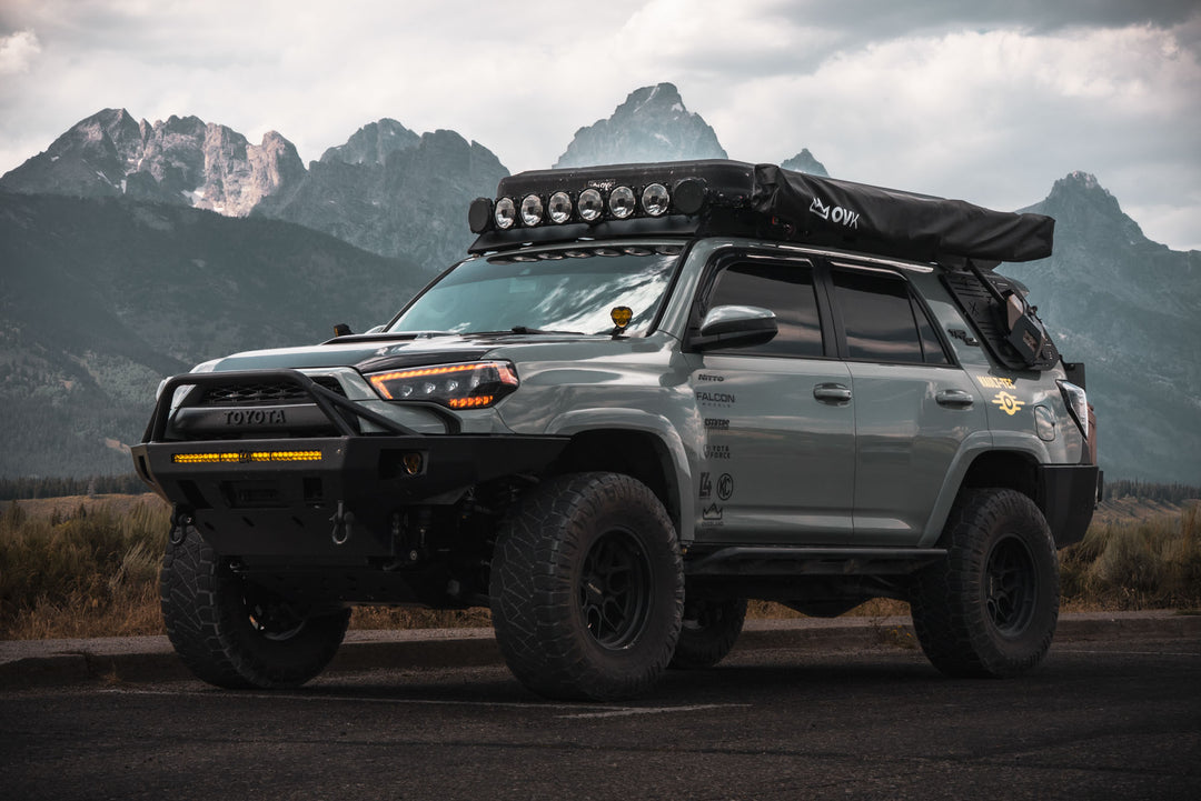 C4 Overland Bumpers and steps on the 5th gen 4runner with camping setup and vault-tec decal.