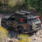 High-angle view of the C4 4Runner build, equipped with bumpers, roof rack, ladder, and MOLLE panels.