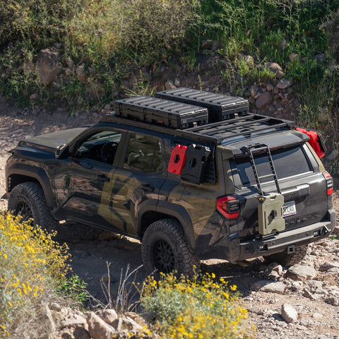 High-angle view of the C4 4Runner build, equipped with bumpers, roof rack, ladder, and MOLLE panels.
