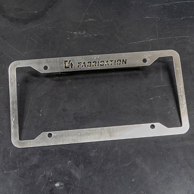 C4 License Plate Frame propped up at an angle on a steel table.