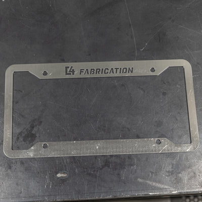 C4 License Plate Frame layed flat on a steel table to show the surface finish ready to be scuffed, polished or painted.