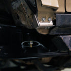 View into the rear of the front wheel well on a 5th Gen 4Runner showing the bottom mount for the High Clearance Fender Liner kit and in the background, the C4 Body Mount Relocation Kit. 