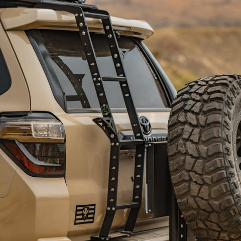 View of the rear hatch area of a tan 4Runner equipped with a C4 Summit hatch ladder. 