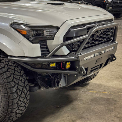 Passenger side view of the Hybrid bumper from C4 for Toyota Tacomas 2024 and newer, installed on a white Tacoma.