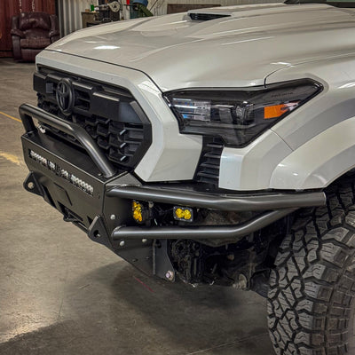 Quartering on shot of the Hybrid bumper from C4 for the 2024 Tacoma installed in a truck along with winch and auxiliary lighting.