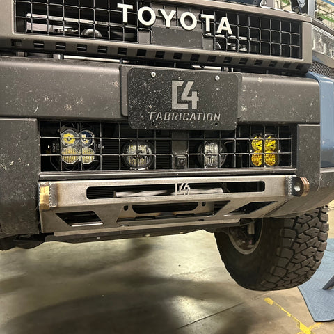 View of the C4 Lo-Pro winch bumper for the Land Cruiser LC250 installed on the vehicle but showing the raw, unfinished state that all C4 bumpers ship in. 