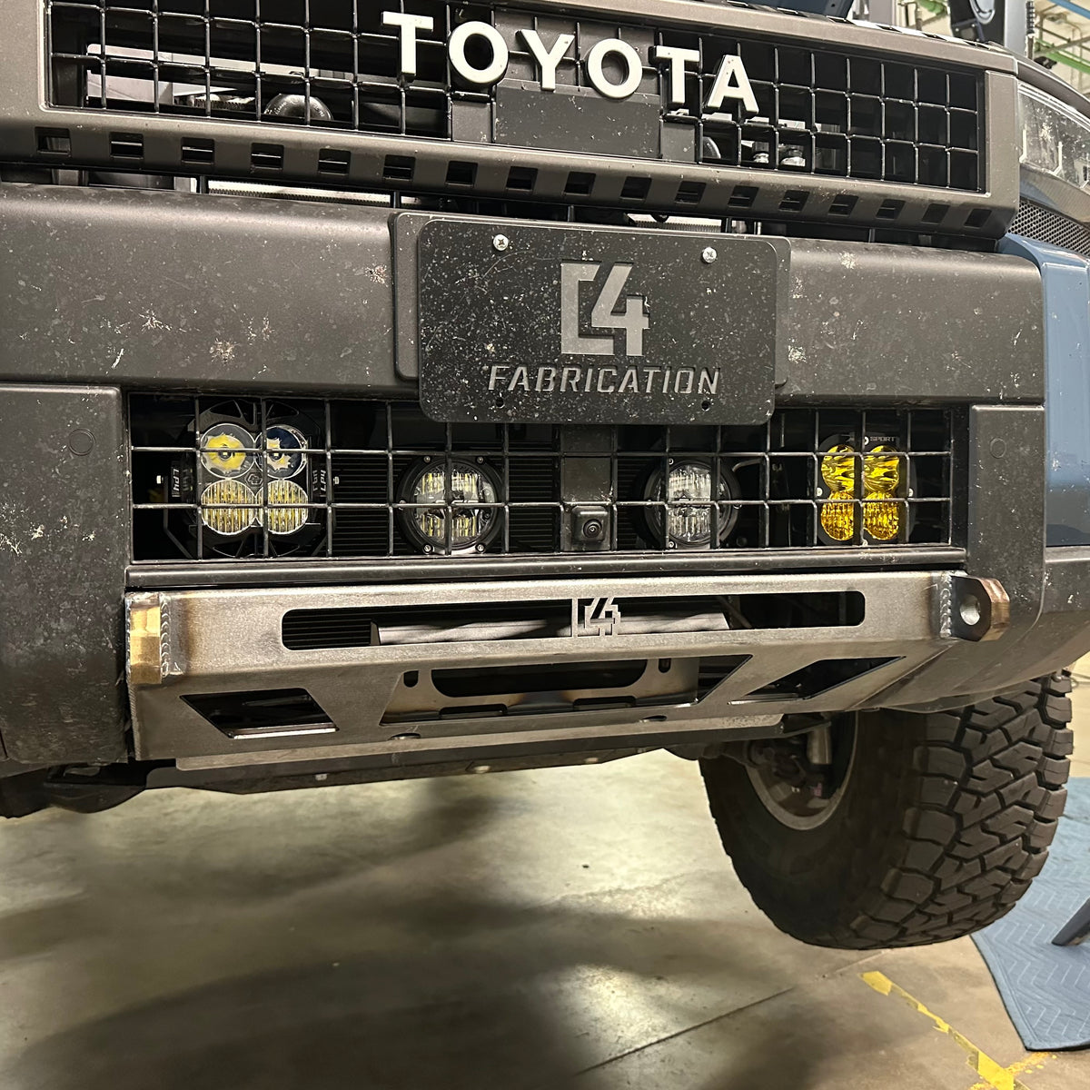 View of the C4 Lo-Pro winch bumper for the Land Cruiser LC250 installed on the vehicle but showing the raw, unfinished state that all C4 bumpers ship in.