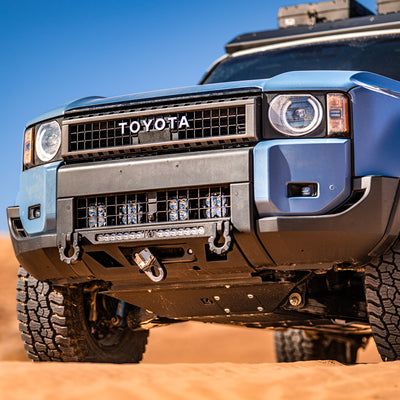 LC250 with the C4 Lo-Pro winch bumper installed offroading in the dunes.