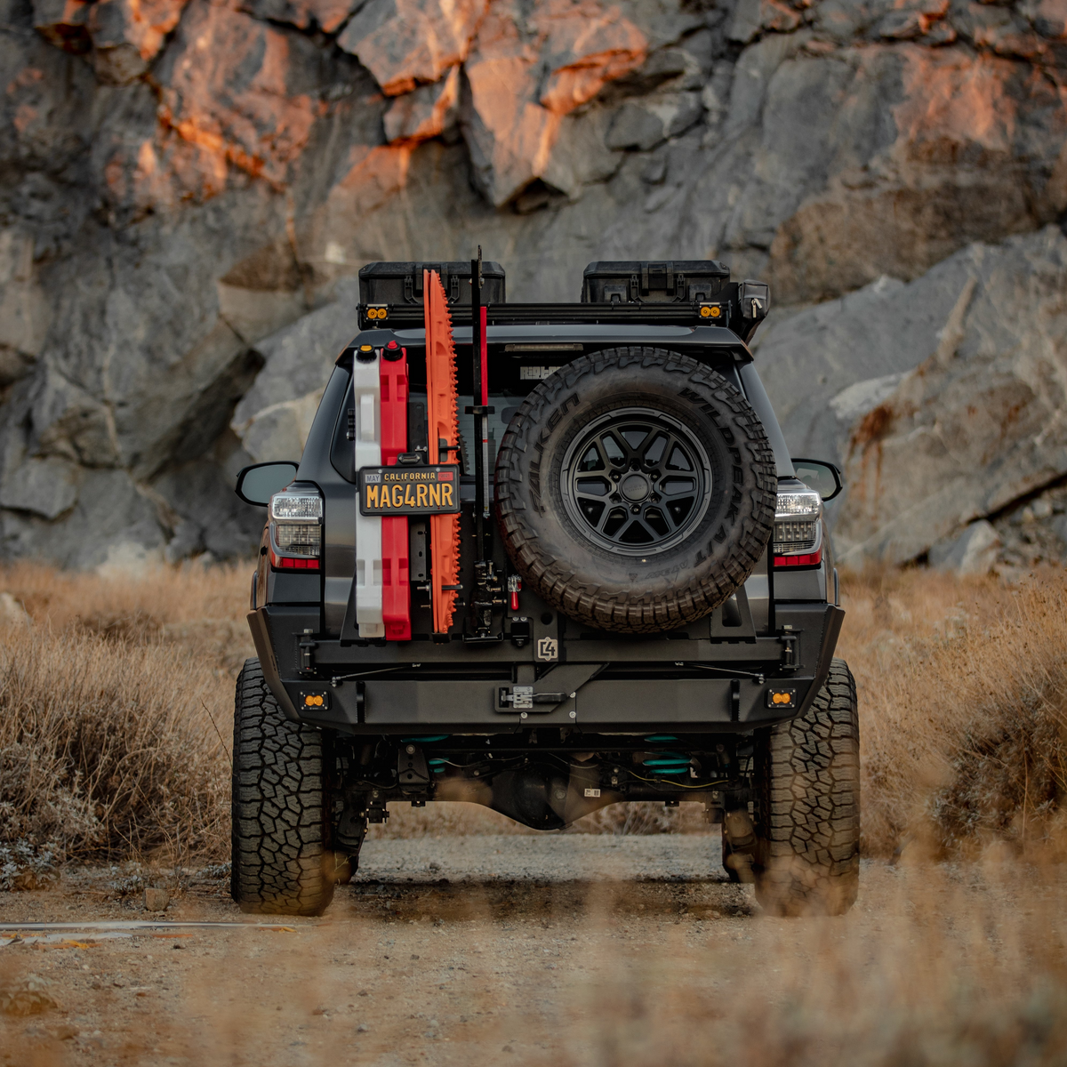 Rear view of a well-modified 5th Generation 4Runner that shows off the C4 Fabrications Overland Rear Bumper with dual swing-outs for its oversized spare tire and accessories.