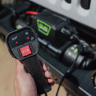 Person holding wired remote control on the DV8 Xtract 9.5k Synthetic Rope Winch, with 12 ft cable