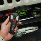 Person holding wireless remote with 150 foot range on the DV8 Xtract 9.5k Synthetic Rope Winch