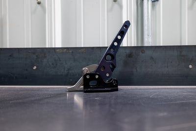 Side view of the C4 billet swing arm latch sitting on a table.