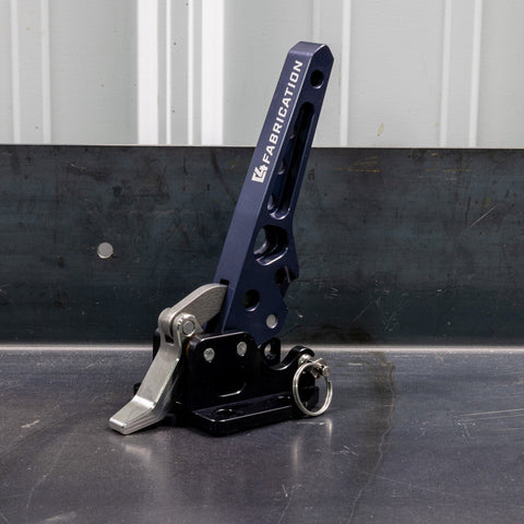 Quartering view of the C4 Fabrication rear swing latch sitting on a metal table.