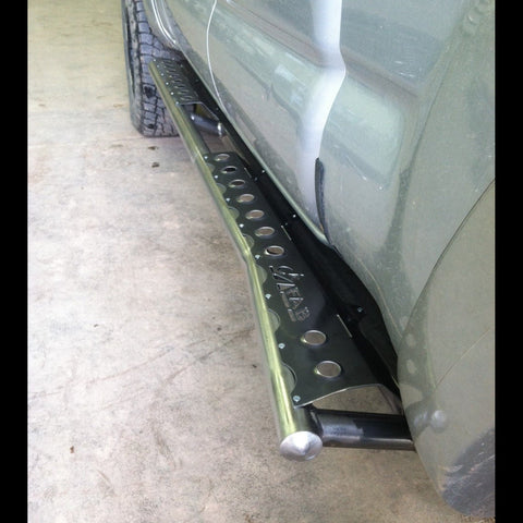Close up view showing the rear kicker on the C4 Sliders for Tacoma that helps protect the rear cab corner and front bed corner from rocks off road. 