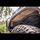 View up underneath the front of the Overized Tire Fitment Kit and its High Clearance Fender Liners from C4 Fabrication.