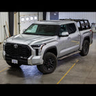 Wide view of a silver 2022+ Tundra equipped with the C4 steel Sliders.