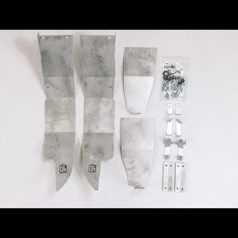 All of the contents of the C4 High Clearance Fender Liner kit laid out on a white table.