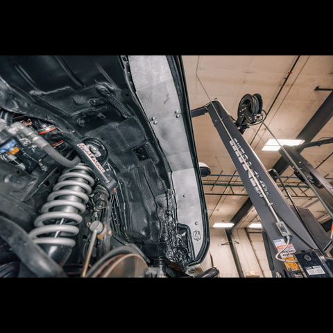View from underneath with the tire off showing the aluminum inner fender liner from C4 Fabrication.